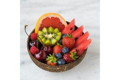 Red berries and other fruit in bowl.